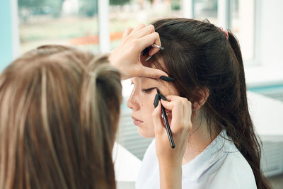 Side view of young woman looking away