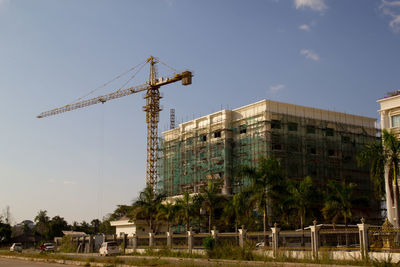 Construction site by building against sky