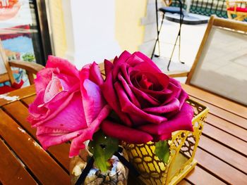 Close-up of pink rose on table