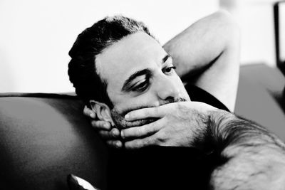 Portrait of young man looking away at home