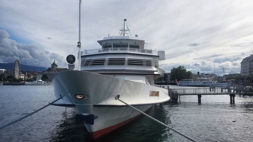 Ship moored at harbor against sky