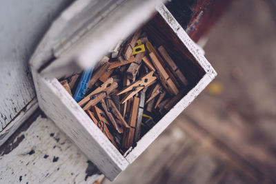 High angle view of wooden clothespins in box