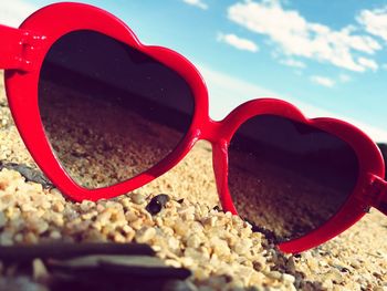 Close-up of sunglasses on beach