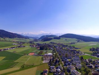 High angle view of agricultural field against clear blue sky