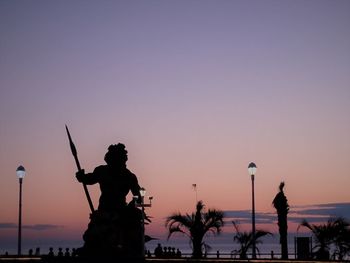 Silhouette statue against clear sky during sunset