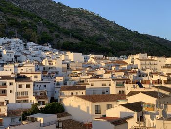 Sun setting over rooftops in the white village of mijas in southern spain. 