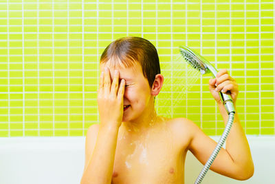 Portrait of shirtless man in a bathroom