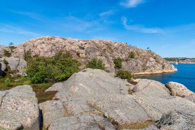 Rock formations in sea against sky