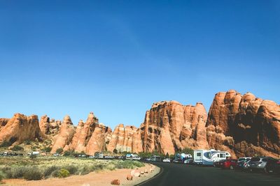 Panoramic view of rock formation against clear blue sky