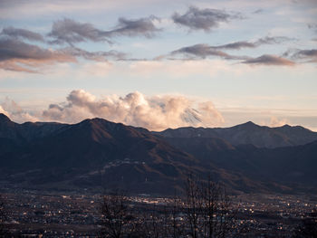 Scenic view of snowcapped mountains against sky at sunset