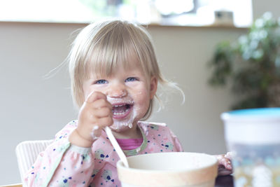 Portrait of cute girl with ice cream in bowl