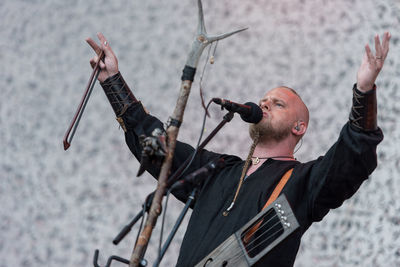 Low angle view of man with arms raised