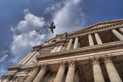 Low angle view of historic building against cloudy sky