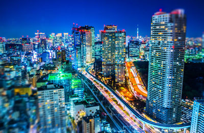 Aerial view of illuminated buildings in city at night