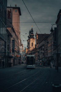 Street amidst buildings in city against sky