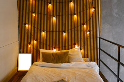 Wooden slats in the headboard of the bed in the scandinavian style. retro light bulbs, bedroom l