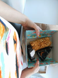 Midsection of woman holding pastries in box