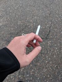 Close-up of hand holding cigarette