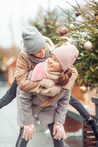 Rear view of mother with baby girl in winter