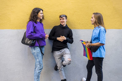 Young diverse friends talking outdoors on the street.