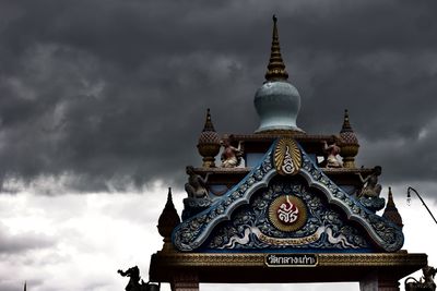 Low angle view of temple building against cloudy sky