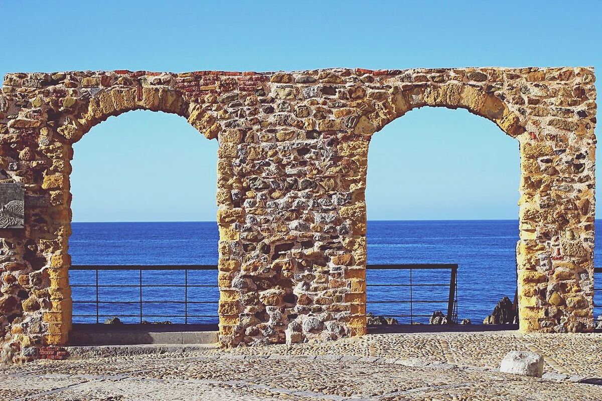 clear sky, blue, architecture, history, sky, sea, archival, no people, horizon over water, architectural column, outdoors, built structure, day, scenics, ancient history, representing, ancient civilization, nature