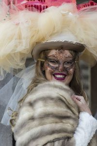 Close-up portrait of smiling woman in costume and mask during event