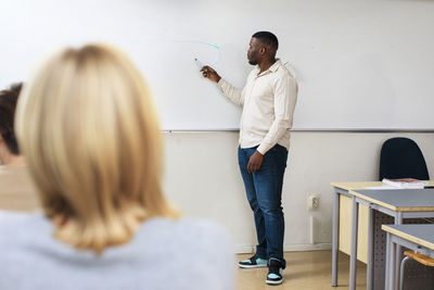 Teacher giving lecture in classroom