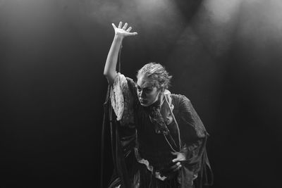 Actress representing a character on the stage of a theater. 