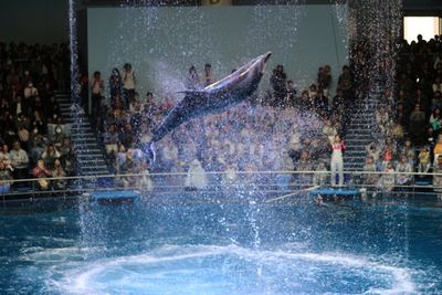 People in swimming pool against sky