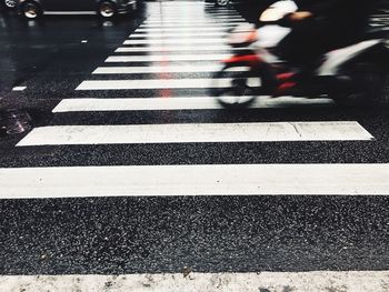 Blurred motion of zebra crossing on road