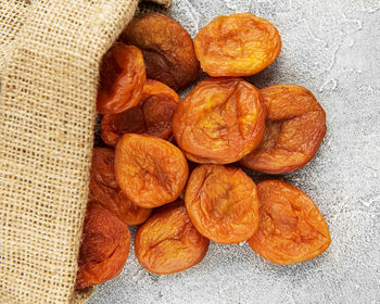 Dried apricots on a grey concrete background
