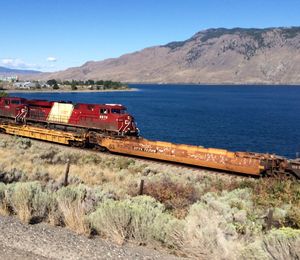 High angle view of train on track at field by lake