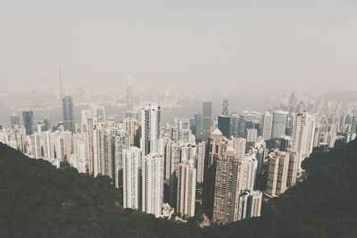 Skyscrapers seen through victoria peak against clear sky