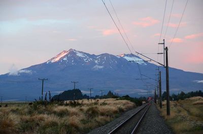 View of railroad tracks against cloudy sky