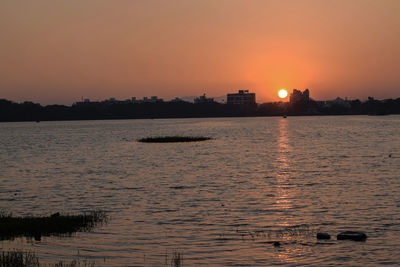 Scenic view of sea against orange sky during sunset