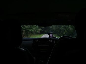 Man seen through car windshield