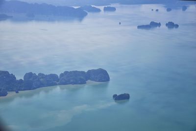 Scenic view of rocks in sea against sky