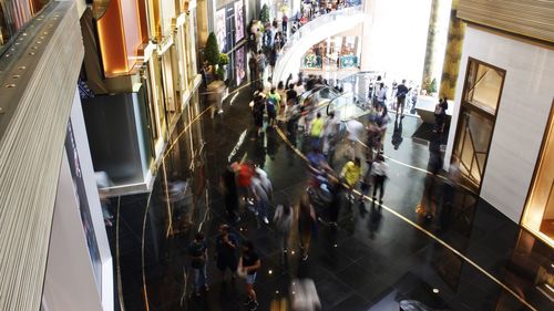 High angle view of people on escalator in shopping mall