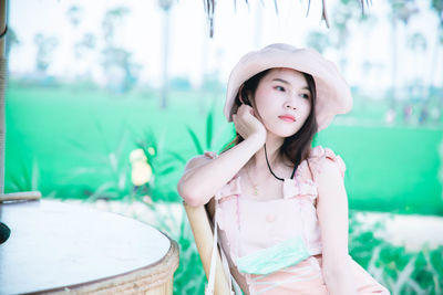 Portrait of girl looking away while standing outdoors