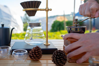 Man grinding coffee bean to make coffee