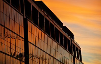 High section of building against cloudy sky at sunset