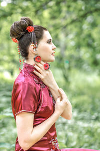 Side view of young woman standing outdoors