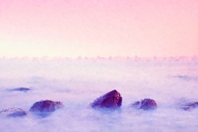 Panoramic shot of purple land against sky during sunset