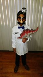 Full length portrait of a young man holding umbrella