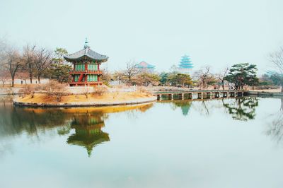 Lake by palace against clear sky