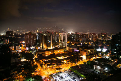 High angle view of illuminated buildings in city at night