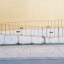 Railing on sidewalk by building