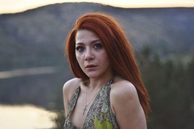 Portrait of beautiful young woman standing outdoors