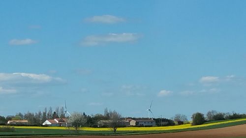 View of rural landscape against blue sky